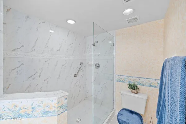 a bathroom with a shower and toilet