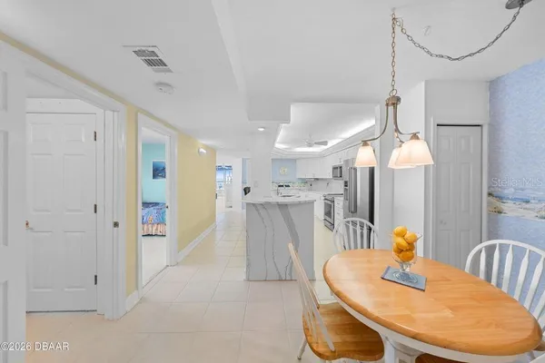 a dining room with furniture a chandelier and wooden floor