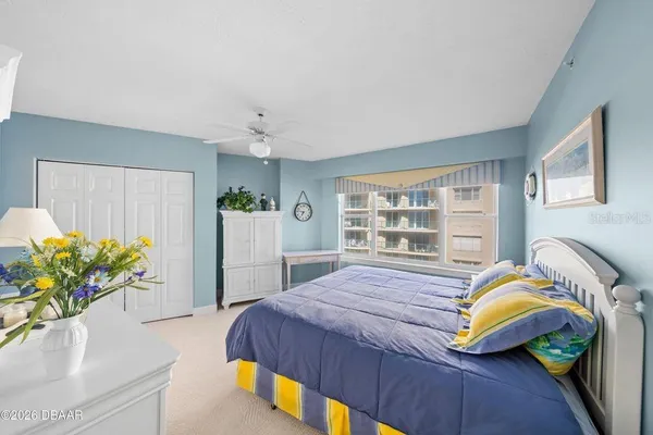 a bedroom with a bed and a potted plant