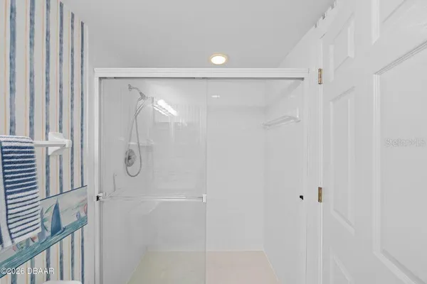 a bathroom with a glass shower door