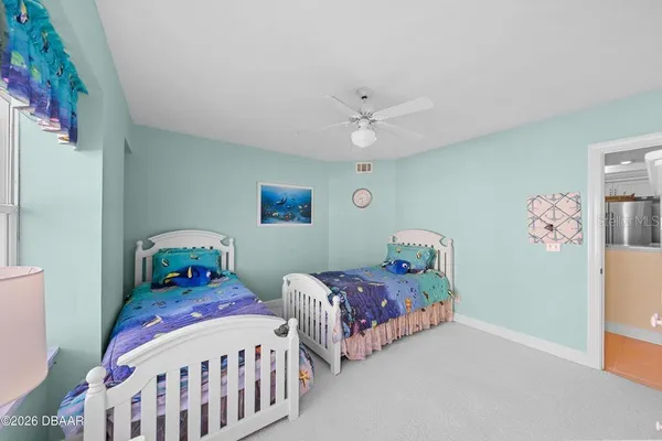 a bedroom with two beds and a chandelier