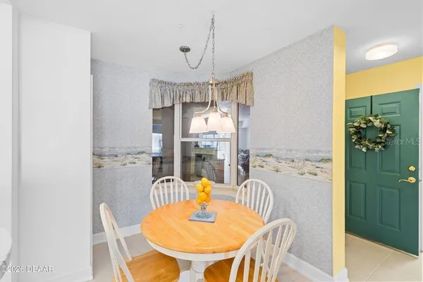 a dining room with furniture a chandelier and wooden floor