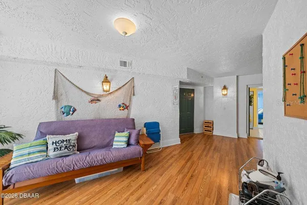 a living room with furniture and wooden floor
