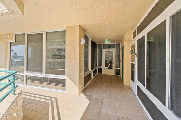 a view of a balcony with wooden floor and furniture