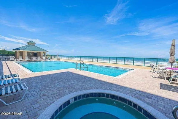 swimming pool view with a seating space