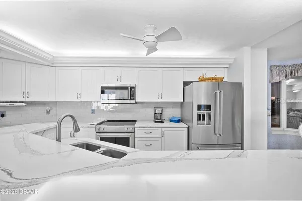 a kitchen with stainless steel appliances a refrigerator sink and cabinets