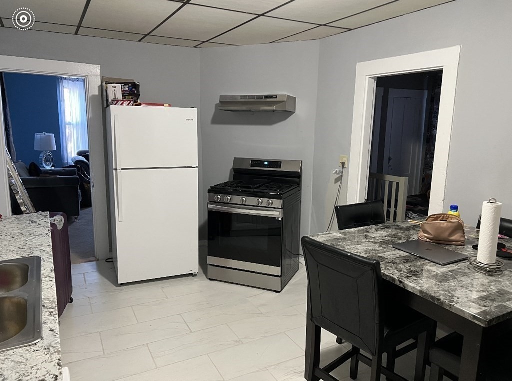 222 Webster Avenue Chelsea, MA 02150 - Photo 3 of 13 a kitchen with a stove and a refrigerator