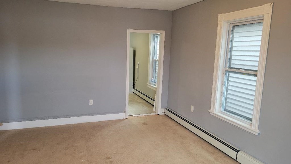 222 Webster Avenue Chelsea, MA 02150 - Photo 8 of 13 an empty room with windows
