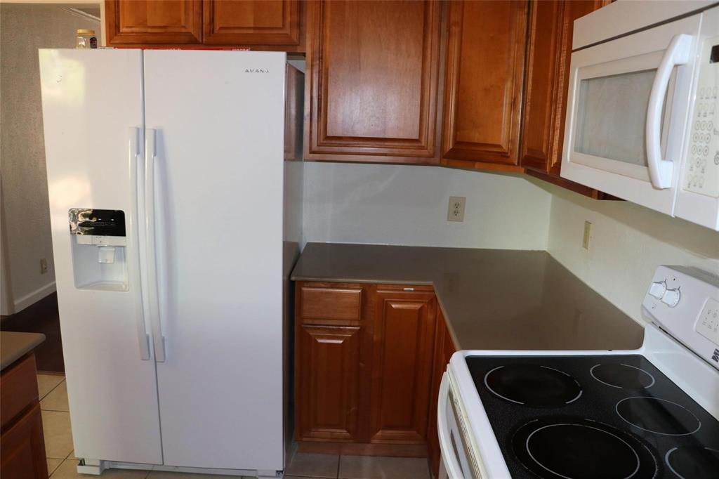 585 Manco Road Lewisville, TX 75067 - Photo 4 of 7 a close view of a refrigerator in kitchen with stainless steel appliances wooden cabinet and refrigerator