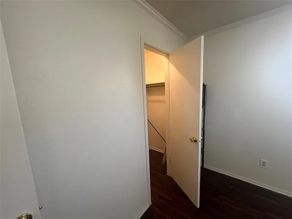 a view of small space with wooden floor and entrance