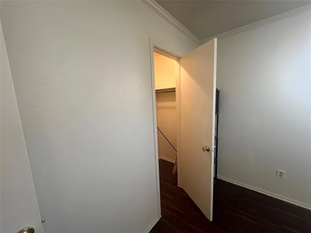 a view of small space with wooden floor and entrance