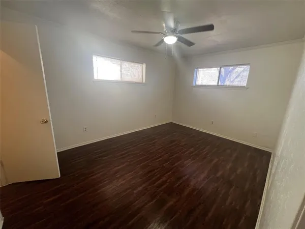a view of a room with wooden floor and window