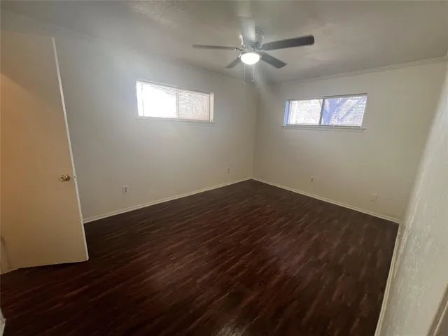 a view of a room with wooden floor and window