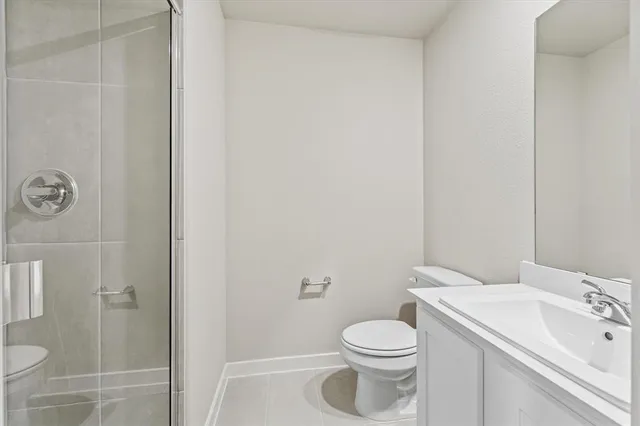 a white toilet sitting next to a bathroom sink
