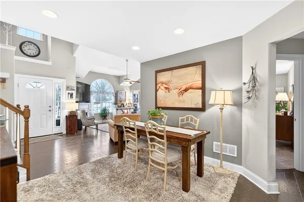 a living room with furniture a rug and a large window