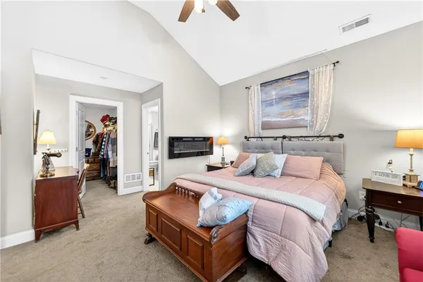 a bedroom with a bed and a view of kitchen