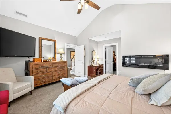 a bedroom with furniture and a flat screen tv