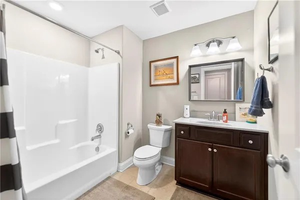 a bath room with a toilet a sink and a bath tub