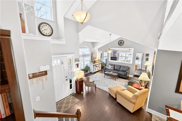 a view of living room with furniture and wooden floor