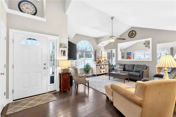 a living room with furniture and wooden floor