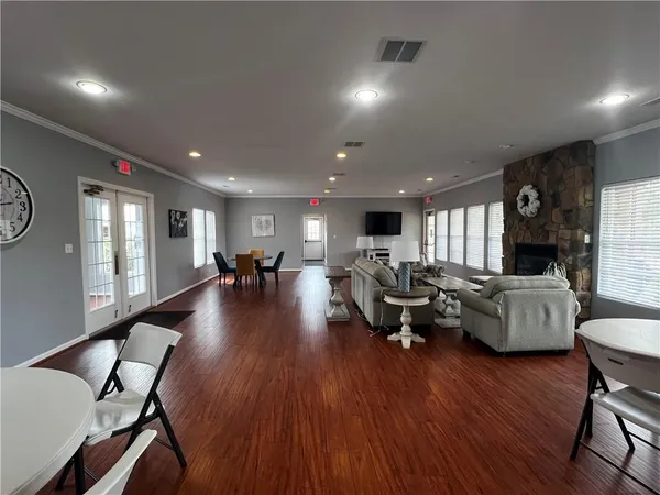 a living room with furniture and a wooden floor