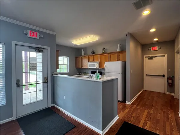 a kitchen with refrigerator and window