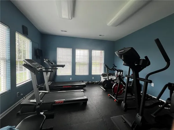 a room with gym equipment and windows