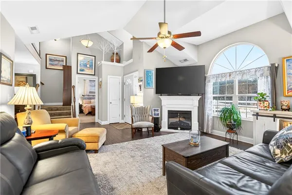 a living room with furniture a fireplace and a flat screen tv