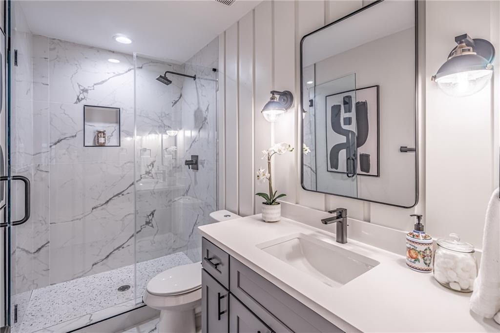 605 Blake Avenue Southeast Atlanta, GA 30316 - Photo 14 of 25 a bathroom with a granite countertop sink toilet and shower