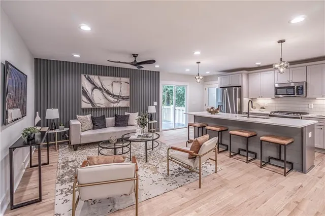 a living room with fireplace furniture and a wooden floor