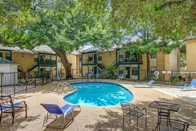 a view of a house with backyard porch and sitting area