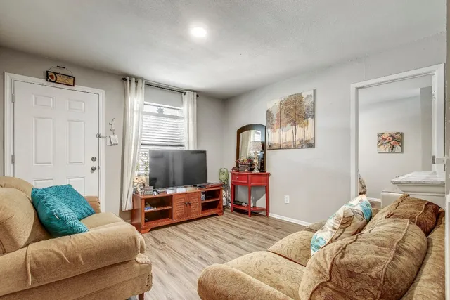 a bedroom with furniture and a wooden floor
