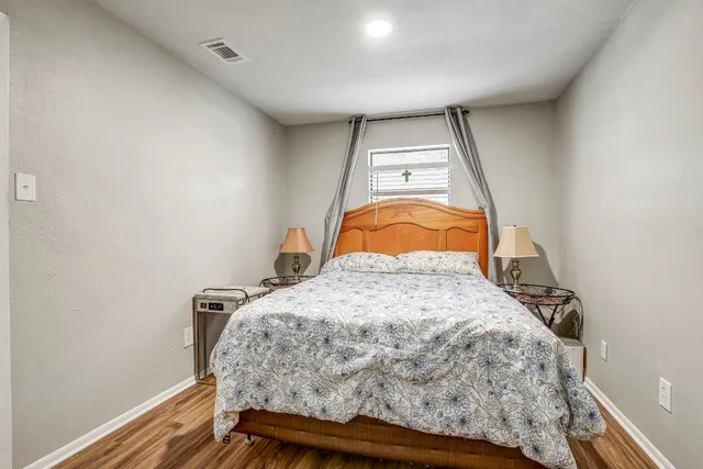 a bedroom with a bed and a window