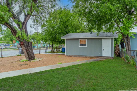 a view of a backyard with a tree