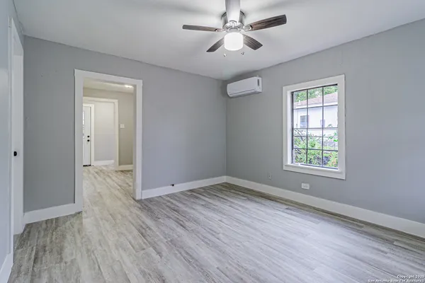 wooden floor in an empty room with a window