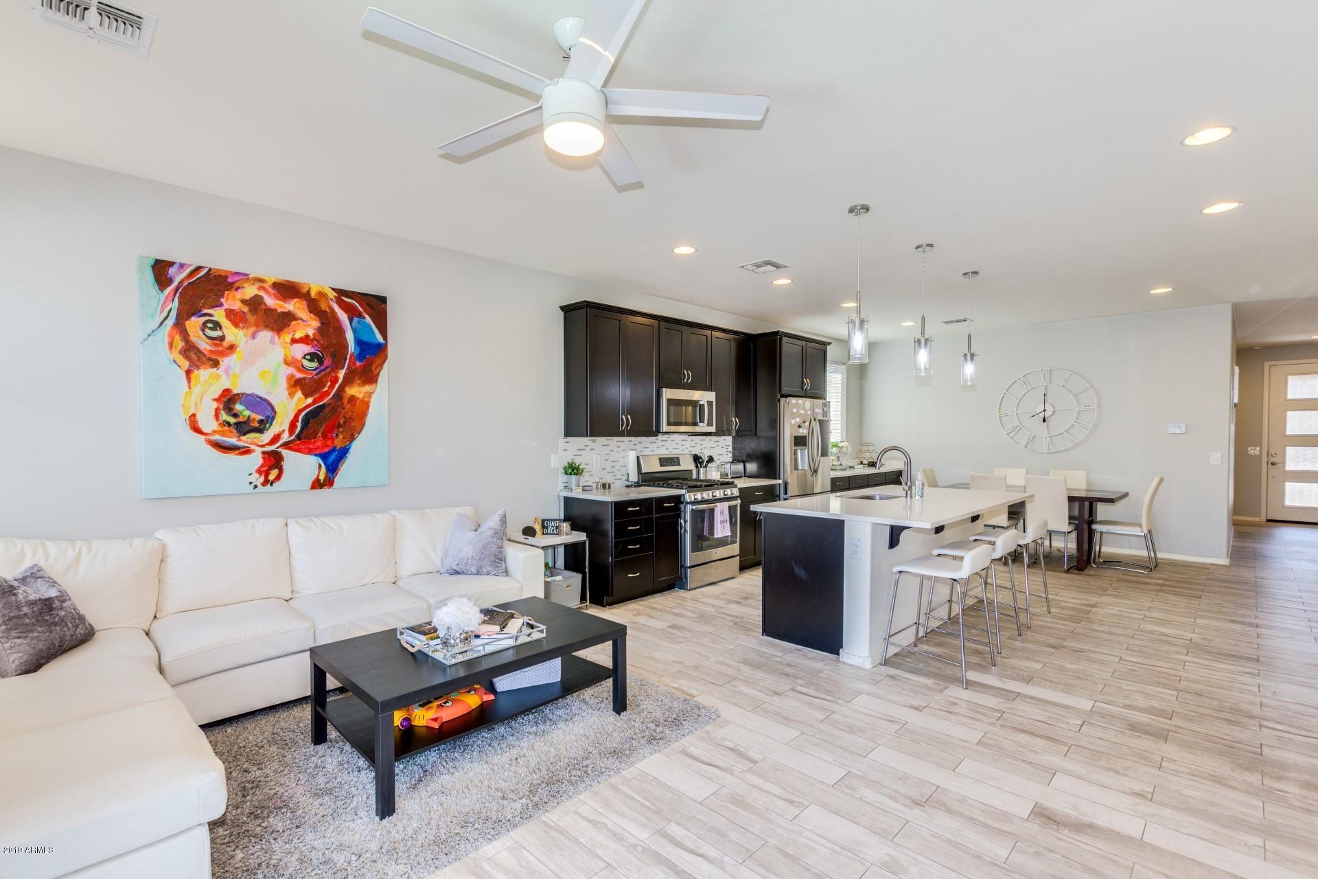 7726 West Shumway Farm Road Laveen, AZ 85339 - Photo 13 of 27 a living room with furniture and kitchen view