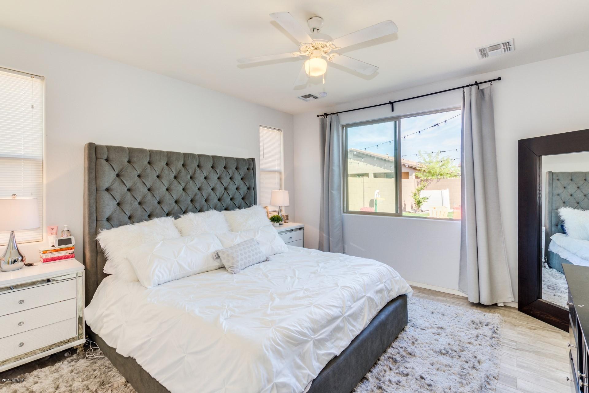 7726 West Shumway Farm Road Laveen, AZ 85339 - Photo 15 of 27 a bedroom with a large bed and a window