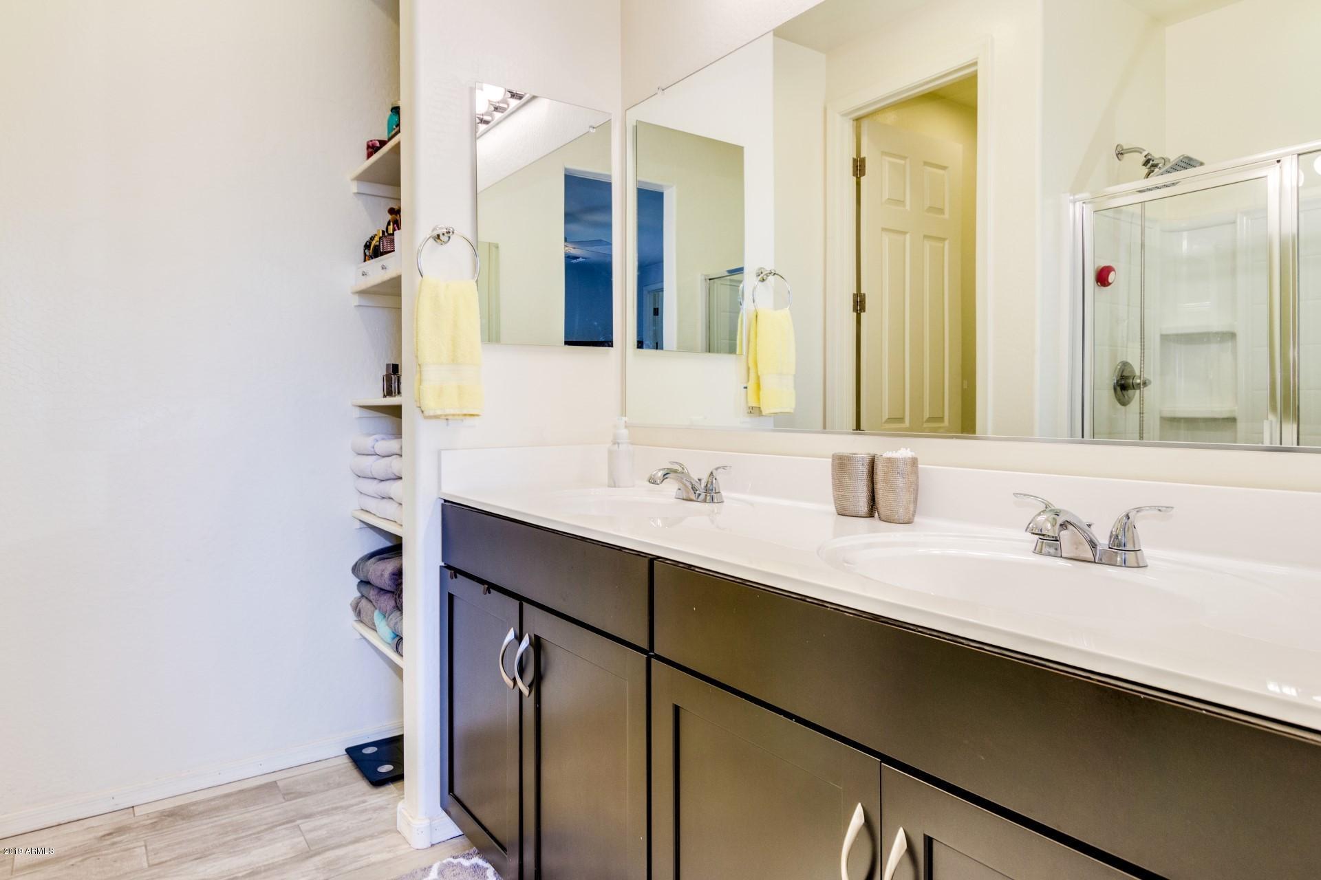 7726 West Shumway Farm Road Laveen, AZ 85339 - Photo 18 of 27 a bathroom with a double vanity sink and mirror