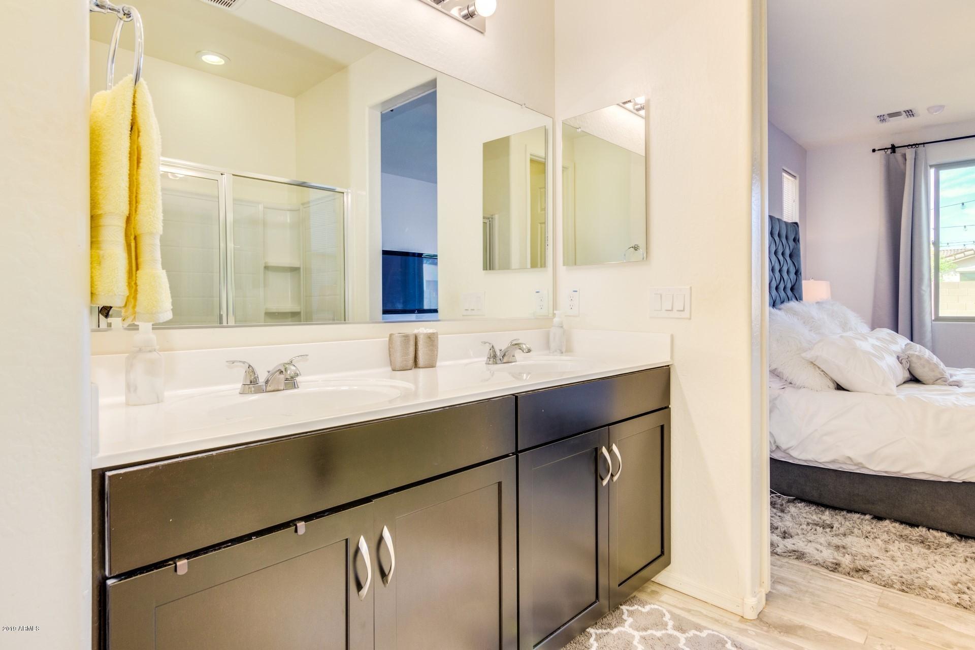 7726 West Shumway Farm Road Laveen, AZ 85339 - Photo 19 of 27 a en suite bathroom with a double vanity sink and a mirror