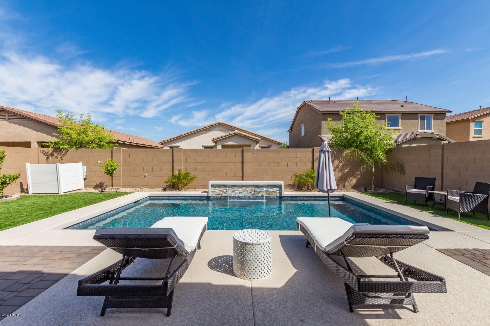 7726 West Shumway Farm Road Laveen, AZ 85339 - Photo 20 of 27 a swimming pool with outdoor seating and yard