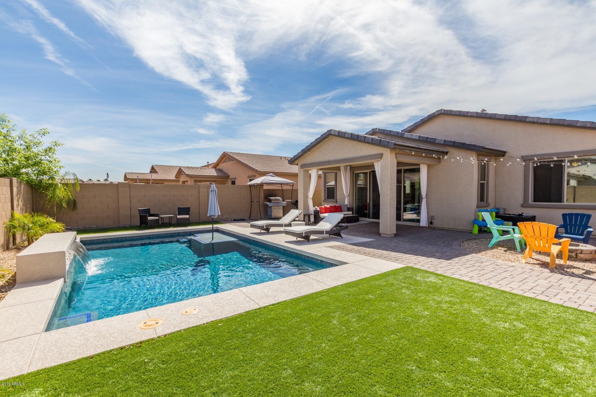 7726 West Shumway Farm Road Laveen, AZ 85339 - Photo 24 of 27 a view of a house with swimming pool and furniture