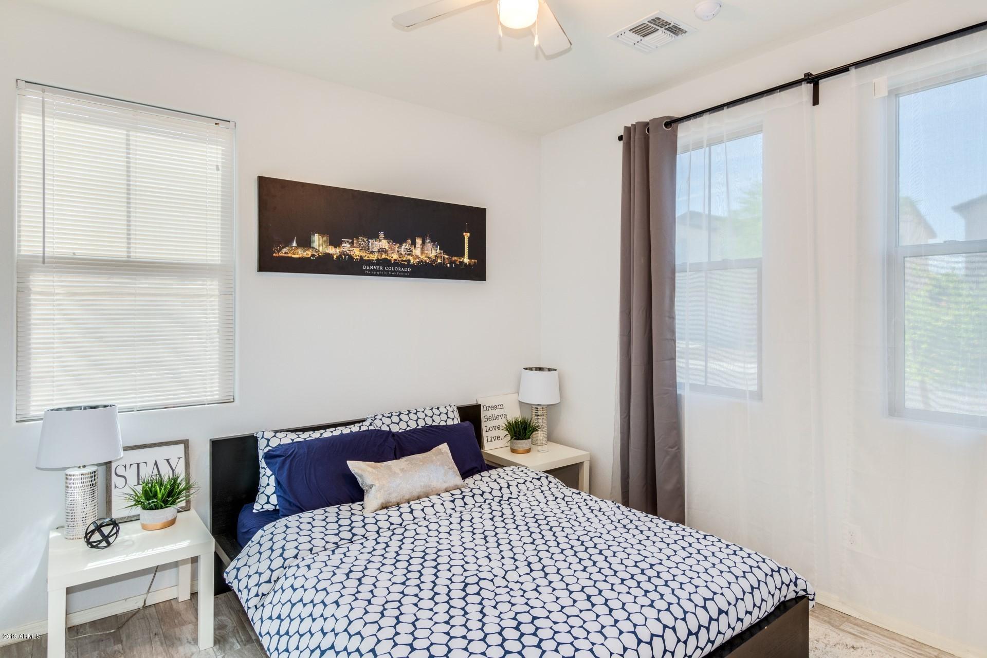 7726 West Shumway Farm Road Laveen, AZ 85339 - Photo 3 of 27 a bedroom with a bed and wooden floor
