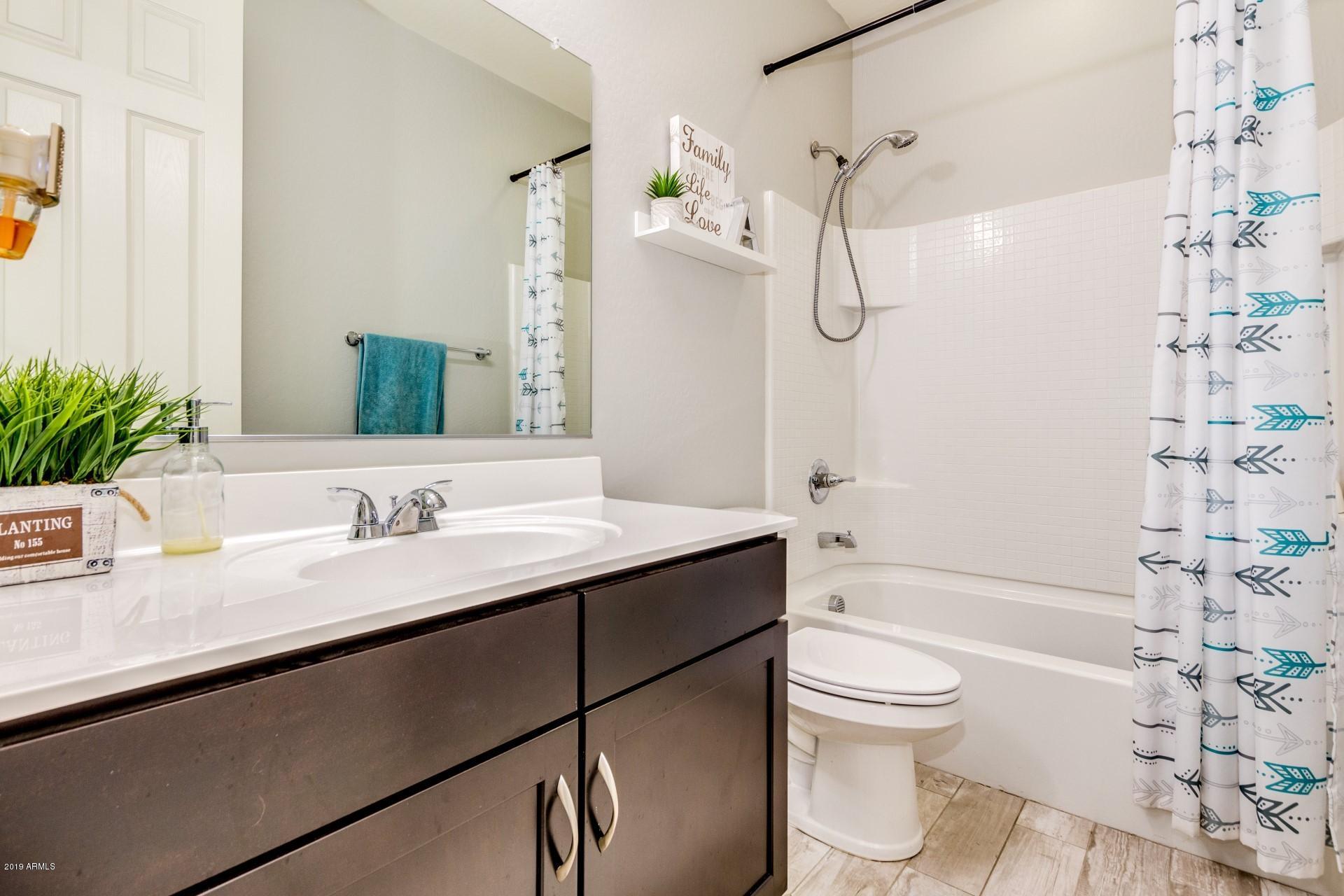 7726 West Shumway Farm Road Laveen, AZ 85339 - Photo 5 of 27 a bathroom with a double vanity sink toilet mirror and shower