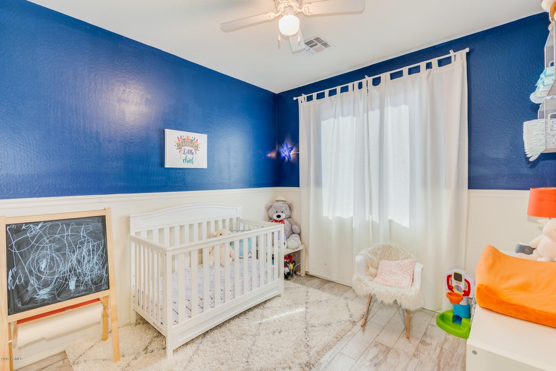 7726 West Shumway Farm Road Laveen, AZ 85339 - Photo 6 of 27 a bedroom with a bed and a window