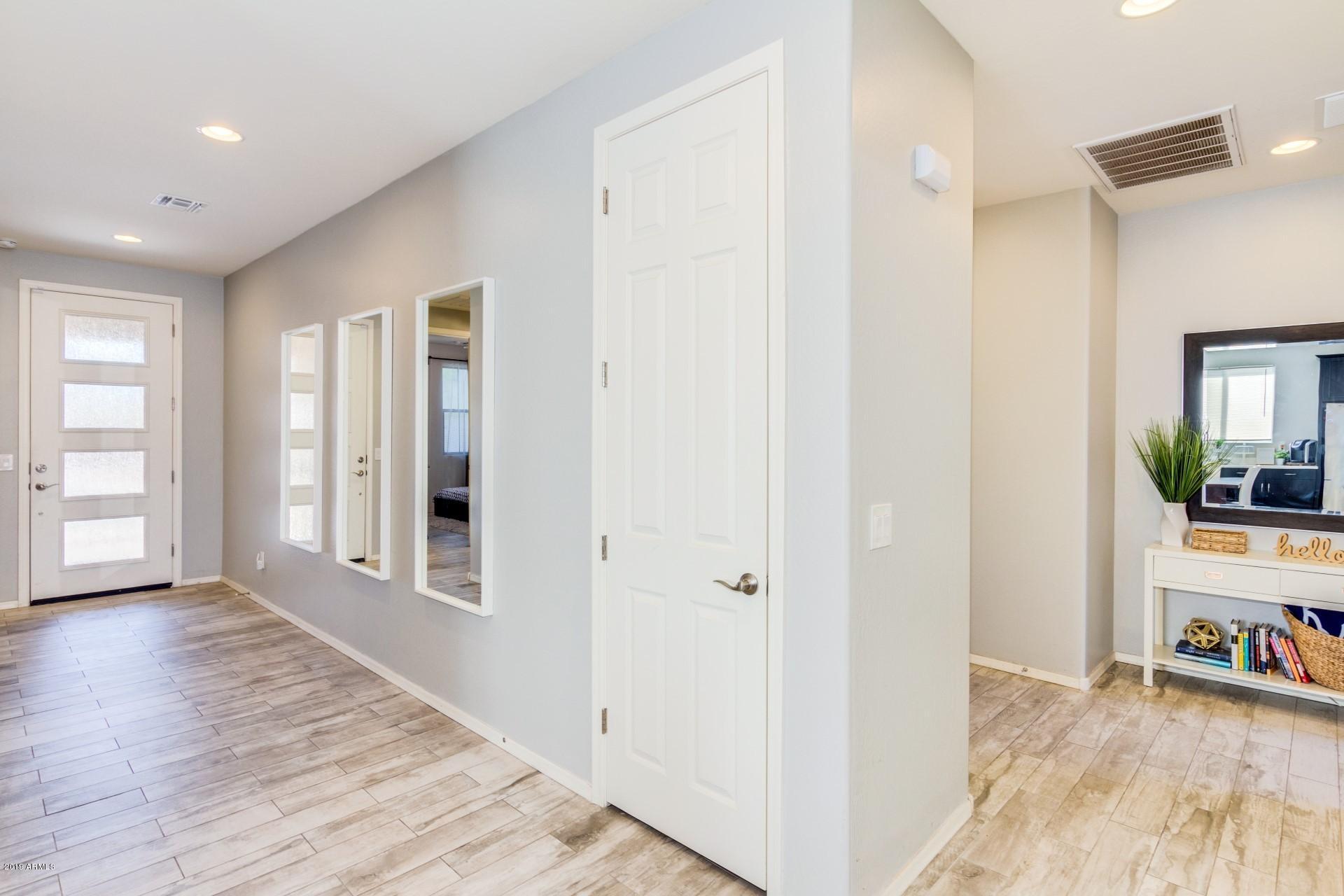 7726 West Shumway Farm Road Laveen, AZ 85339 - Photo 8 of 27 wooden floor with white walls