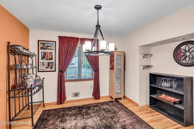 a view of a hallway with wooden floor and entryway
