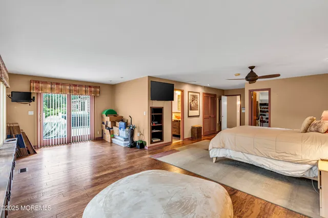 a spacious bedroom with a large bed and a large window