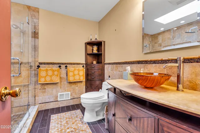 a bathroom with a sink a toilet and shower