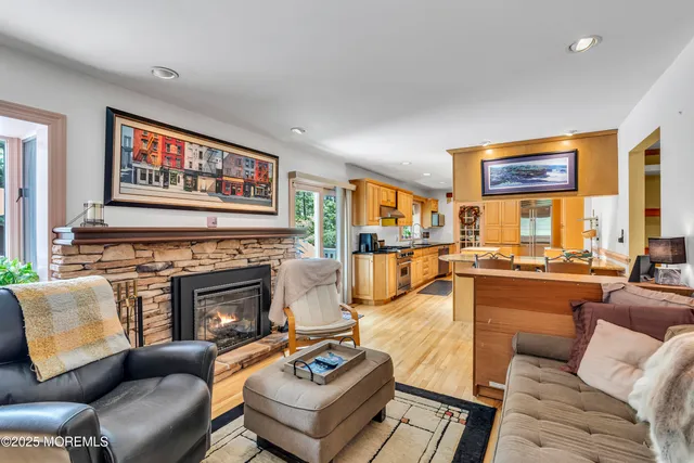 a living room with furniture kitchen view and a fireplace