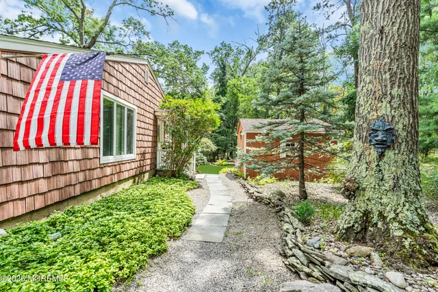 a view of a house with a yard and pathway